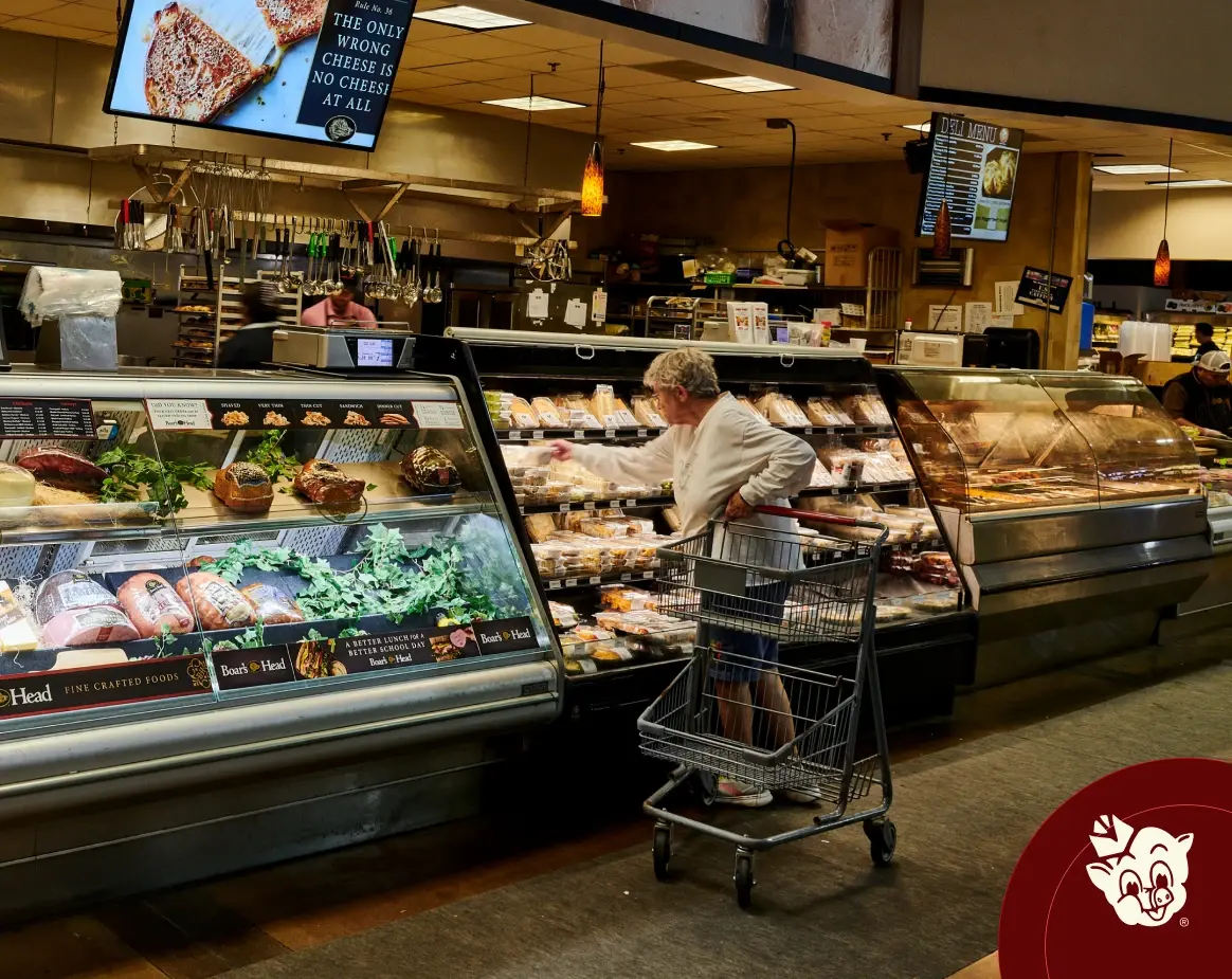 Customer shopping at full service deli and fresh meat counter inside Russell’s Piggly Wiggly grocery store