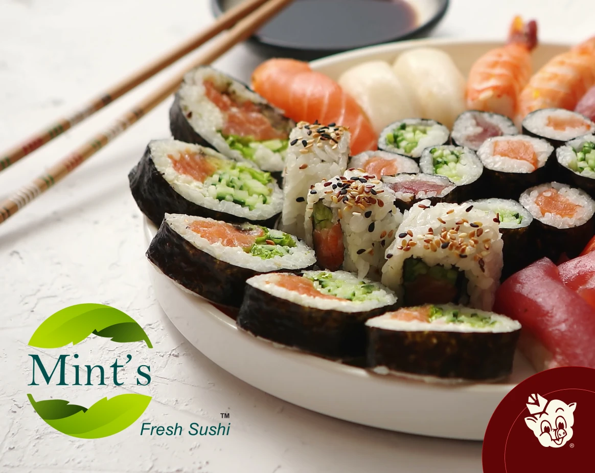 Assorted sushi platter with salmon rolls cucumber maki sesame topped rolls and nigiri served with chopsticks and soy sauce